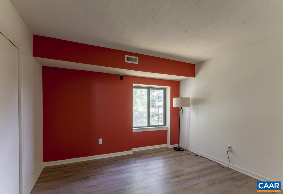 47 Spring Court Charlottesville, VA 22901 - Photo 10 of 17 an empty room with wooden floor and windows