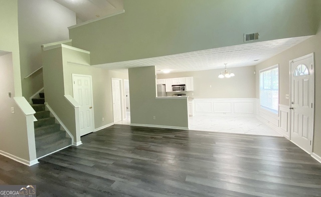 646 Lakes Circle Lithonia, GA 30058 - Photo 16 of 32 a view of a hallway with wooden floor