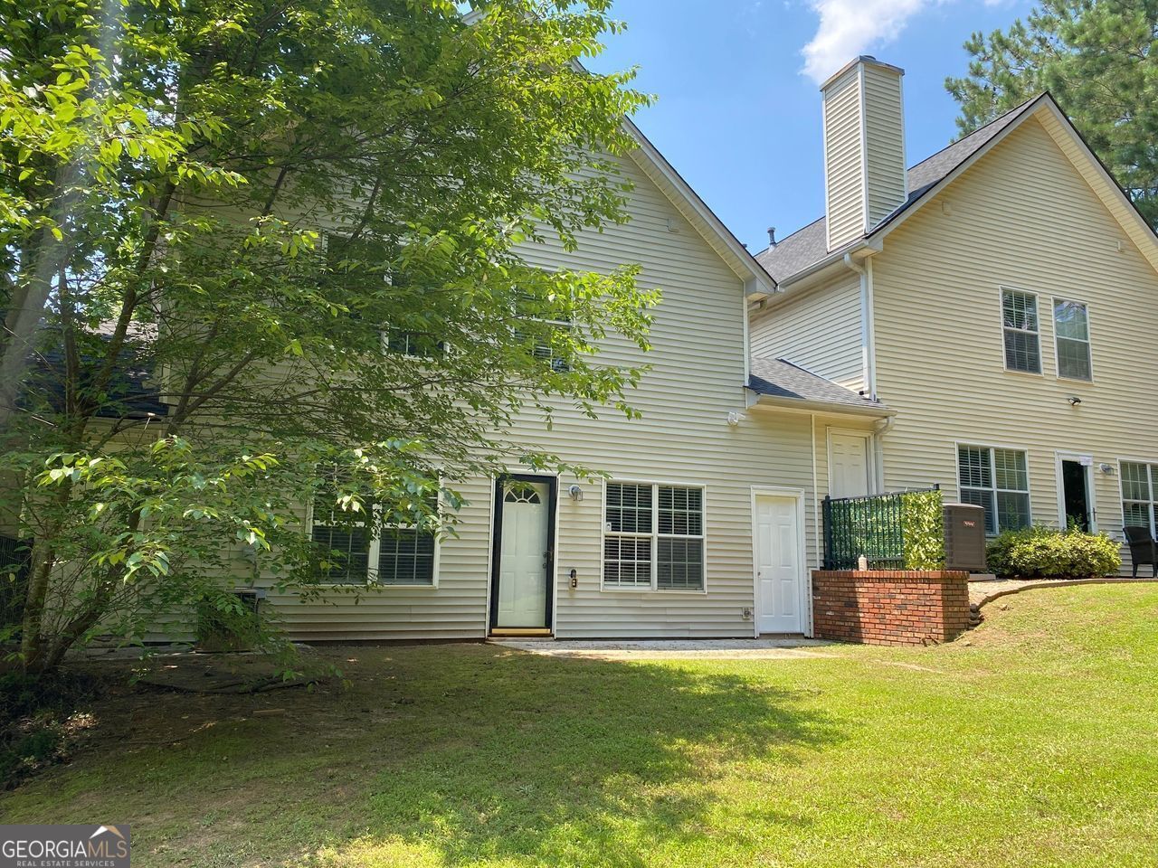 646 Lakes Circle Lithonia, GA 30058 - Photo 2 of 32 a front view of a house with a yard and garage