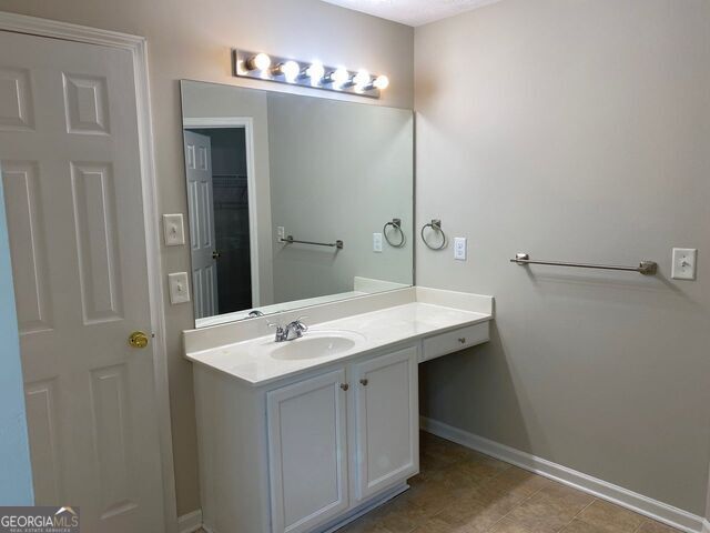 646 Lakes Circle Lithonia, GA 30058 - Photo 22 of 32 a bathroom with a sink and a mirror