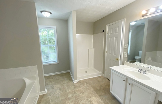 646 Lakes Circle Lithonia, GA 30058 - Photo 24 of 32 a bathroom with a sink a toilet and shower