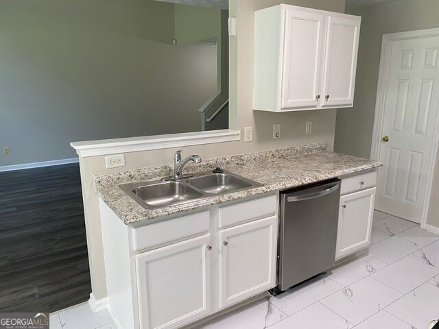 646 Lakes Circle Lithonia, GA 30058 - Photo 4 of 32 a sink with granite countertop white cabinets and a sink