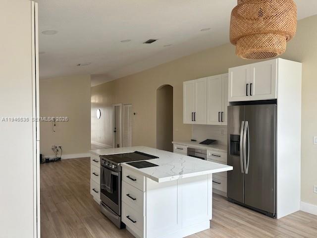 1924 Southeast 11th Street Homestead, FL 33035 - Photo 11 of 21 a kitchen with a stove a refrigerator and a wooden floor