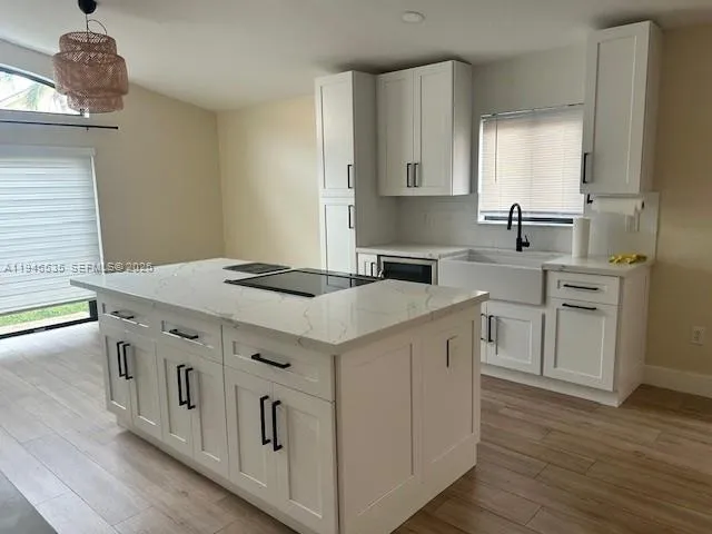 a kitchen with stainless steel appliances granite countertop a sink and dishwasher a stove with wooden floor