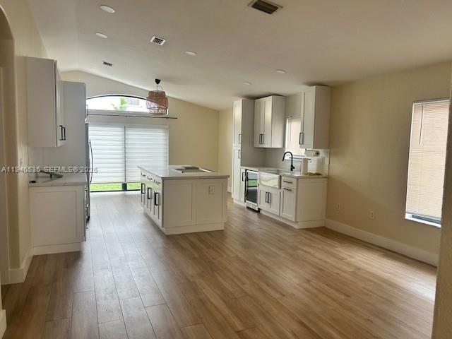 1924 Southeast 11th Street Homestead, FL 33035 - Photo 14 of 21 a room with stainless steel appliances wooden floors and white walls