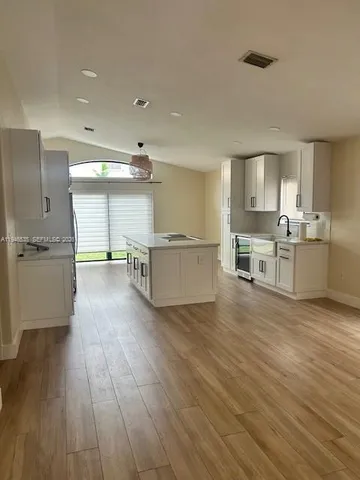 a view of kitchen with wooden floor