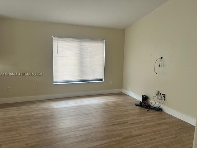 1924 Southeast 11th Street Homestead, FL 33035 - Photo 2 of 21 a view of an empty room with wooden floor and a window
