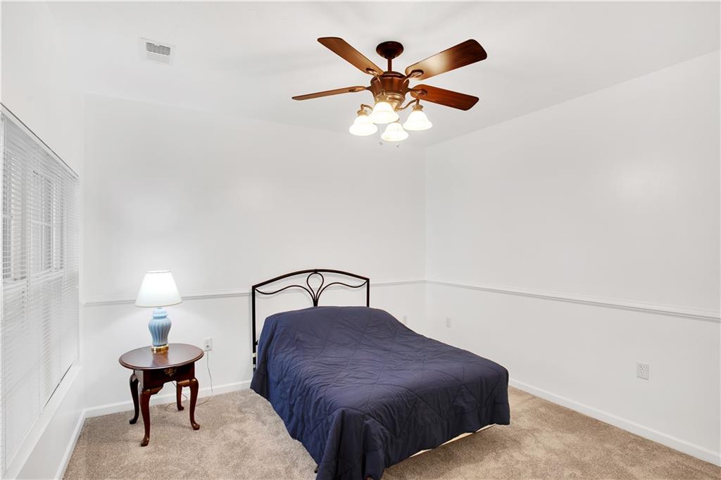 808 Stockton Ridge Cranberry Township, PA 16066 - Photo 17 of 25 a bedroom with a bed and a chandelier