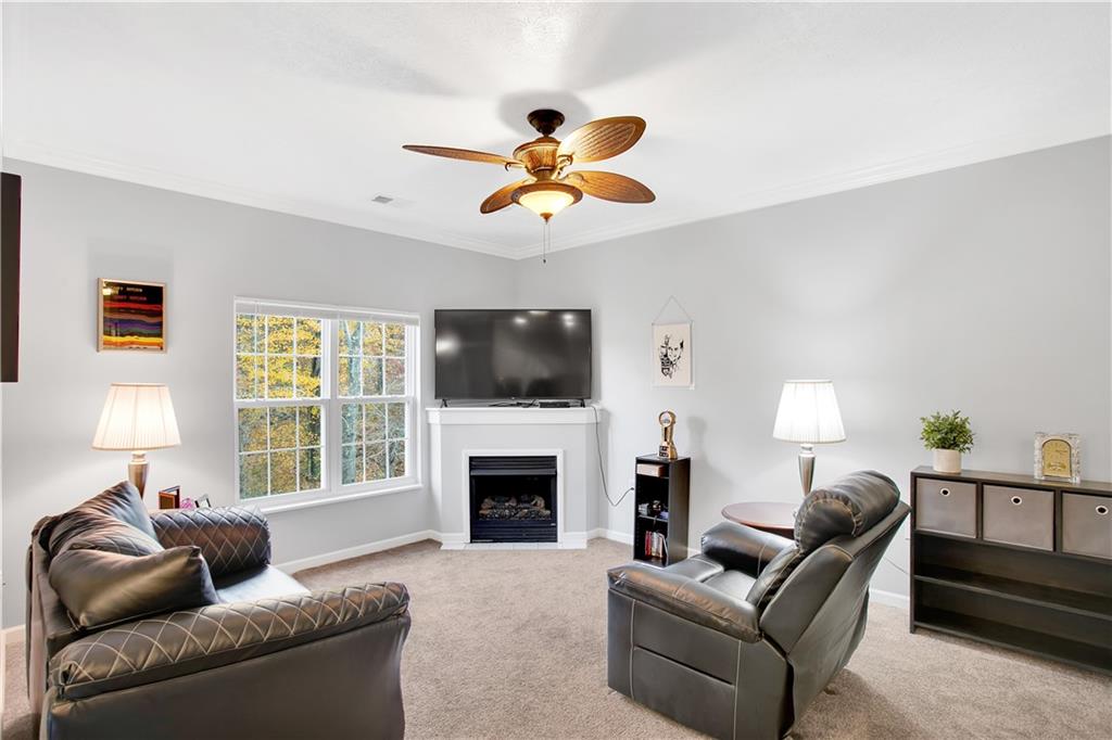 808 Stockton Ridge Cranberry Township, PA 16066 - Photo 4 of 25 a living room with furniture a fireplace and a flat screen tv