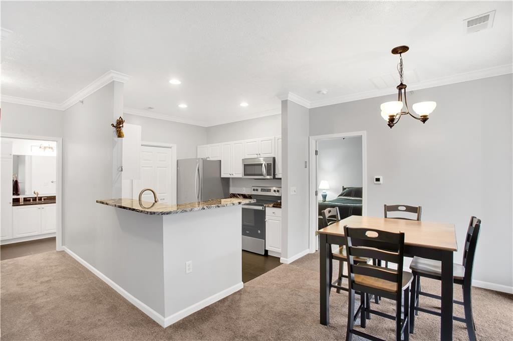 808 Stockton Ridge Cranberry Township, PA 16066 - Photo 5 of 25 a view of a dining room and kitchen with furniture wooden floor and a chandelier