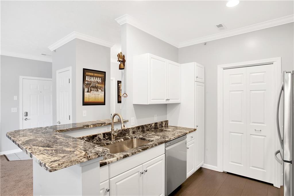 808 Stockton Ridge Cranberry Township, PA 16066 - Photo 6 of 25 a kitchen with stainless steel appliances granite countertop a sink stove and cabinets