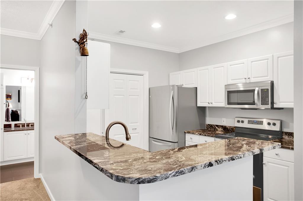808 Stockton Ridge Cranberry Township, PA 16066 - Photo 8 of 25 a kitchen with stainless steel appliances granite countertop a sink a stove a refrigerator and cabinets