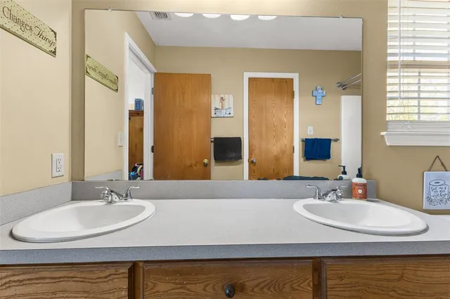 a bathroom with a sink and a mirror