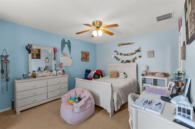 a room with furniture and a chandelier fan