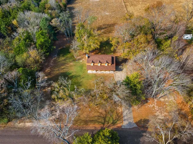 an aerial view of a house with a yard