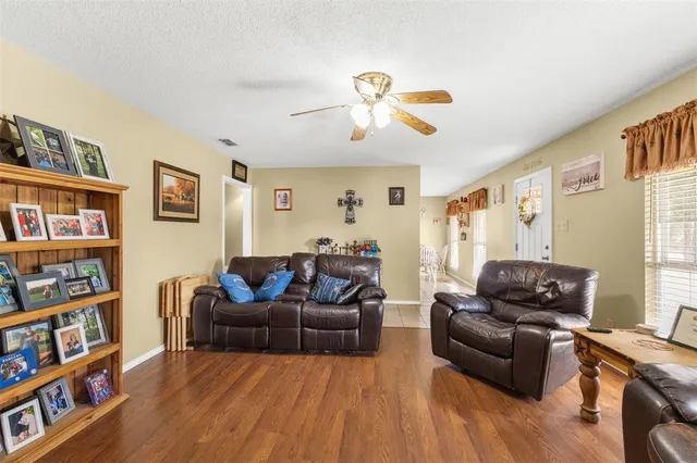 a living room with furniture and a book shelf