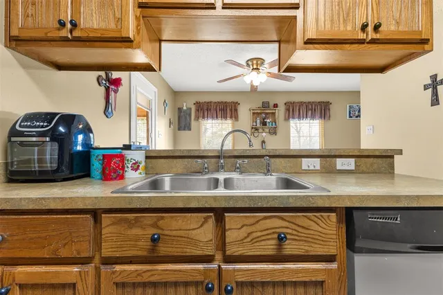 a kitchen with a sink and a wooden floor