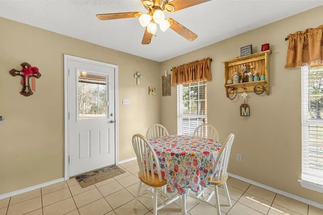 a dining room with furniture and window