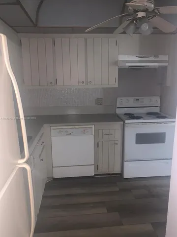 a white toilet sitting next to a white sink