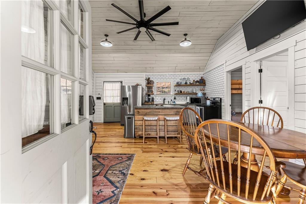 121 Waterfalls Way Clarkesville, GA 30523 - Photo 13 of 60 a living room with lots of furniture and a flat screen tv