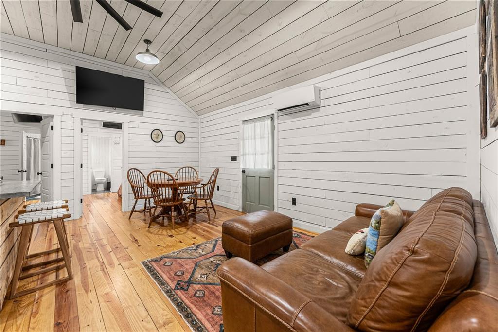 121 Waterfalls Way Clarkesville, GA 30523 - Photo 14 of 60 a view of a patio with table and chairs with wooden floor