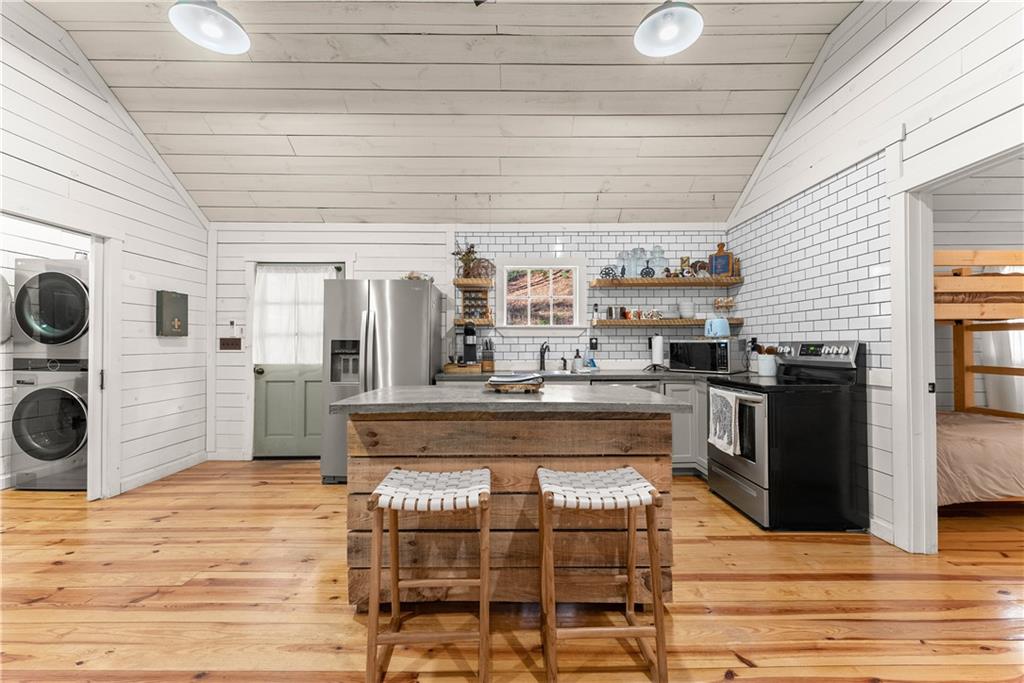 121 Waterfalls Way Clarkesville, GA 30523 - Photo 17 of 60 a view of a kitchen with a stove and cabinets