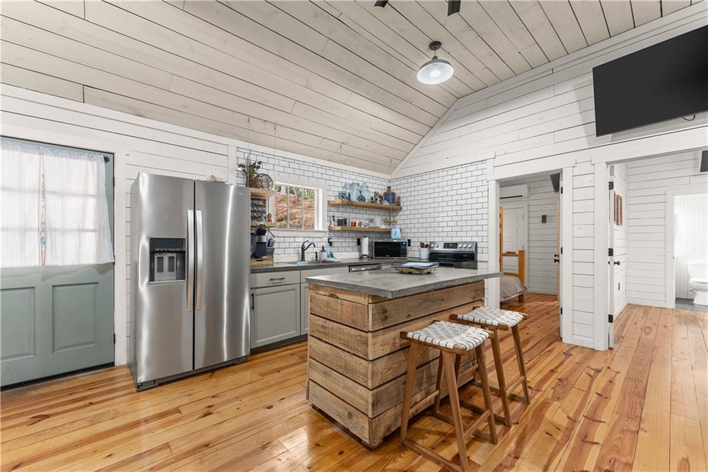121 Waterfalls Way Clarkesville, GA 30523 - Photo 18 of 60 a kitchen with stainless steel appliances granite countertop a stove refrigerator and cabinets