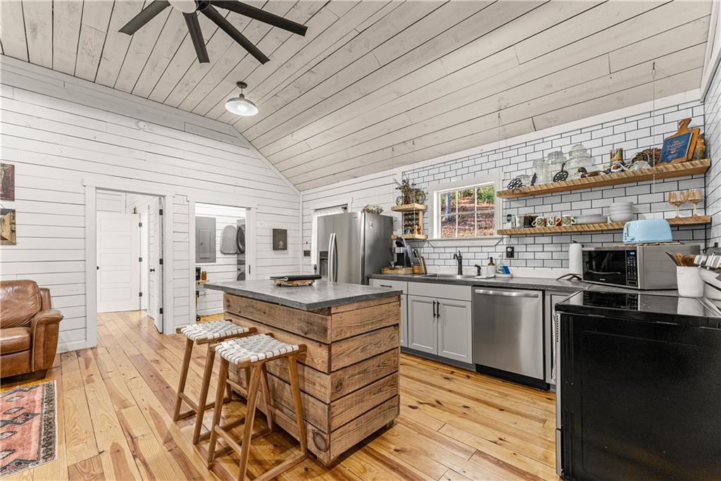 121 Waterfalls Way Clarkesville, GA 30523 - Photo 19 of 60 a kitchen with stainless steel appliances granite countertop a stove and cabinets