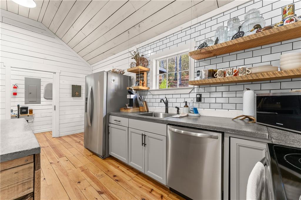 121 Waterfalls Way Clarkesville, GA 30523 - Photo 20 of 60 a kitchen with stainless steel appliances granite countertop a sink stove and refrigerator