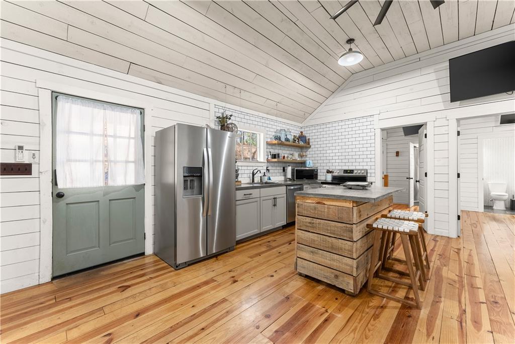 121 Waterfalls Way Clarkesville, GA 30523 - Photo 23 of 60 a kitchen with stainless steel appliances a refrigerator and a stove top oven