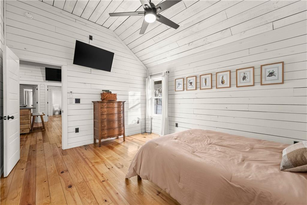 121 Waterfalls Way Clarkesville, GA 30523 - Photo 27 of 60 a spacious bedroom with a bed and a flat screen tv