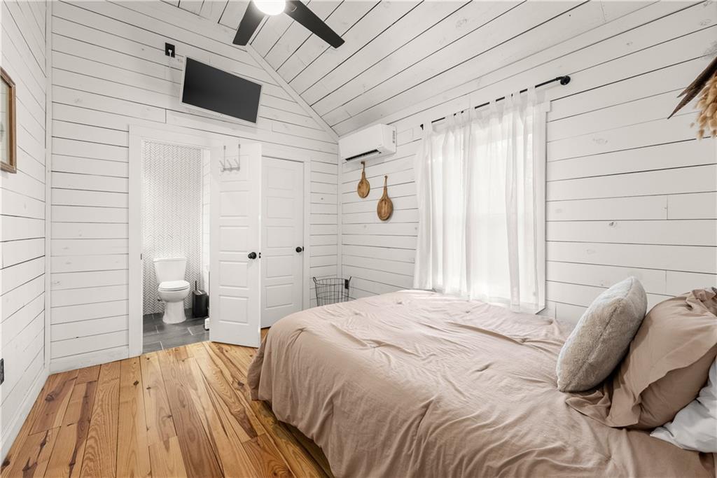 121 Waterfalls Way Clarkesville, GA 30523 - Photo 29 of 60 a bedroom with a bed and a flat screen tv