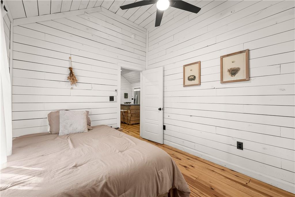 121 Waterfalls Way Clarkesville, GA 30523 - Photo 30 of 60 a bedroom with a bed and a ceiling fan