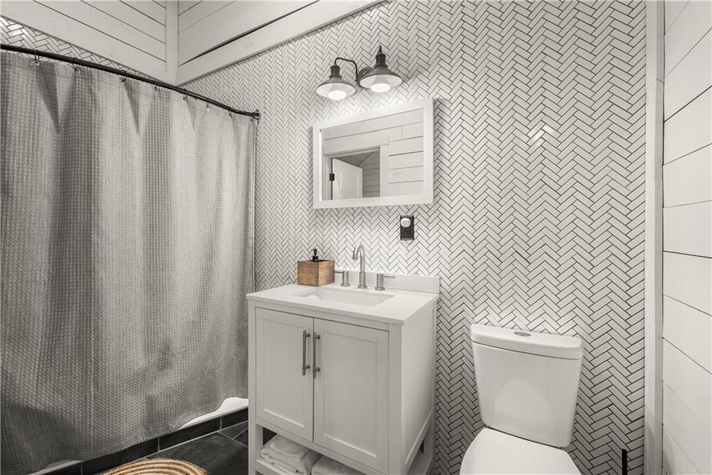 121 Waterfalls Way Clarkesville, GA 30523 - Photo 31 of 60 a bathroom with a sink a toilet and mirror