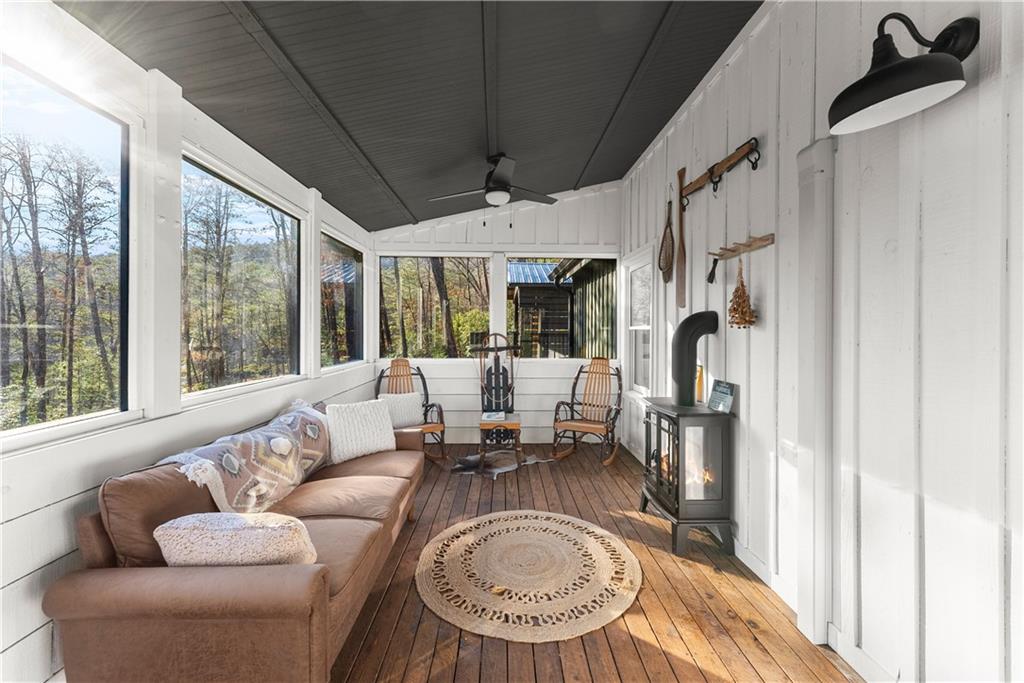 121 Waterfalls Way Clarkesville, GA 30523 - Photo 36 of 60 a living room with furniture a large window and a chandelier