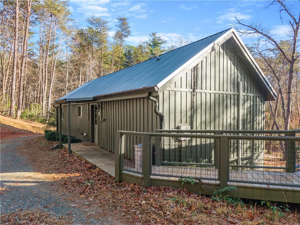 121 Waterfalls Way Clarkesville, GA 30523 - Photo 39 of 60 a view of wooden house with a small yard and wooden fence