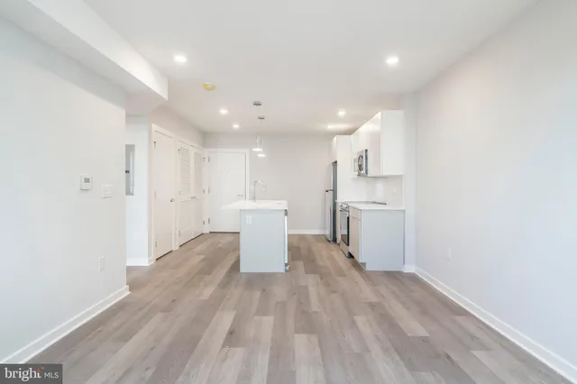 a view of a kitchen with wooden floor
