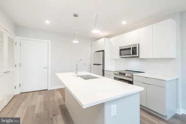 a kitchen with stainless steel appliances a microwave sink stove and refrigerator