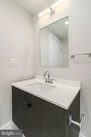 a bathroom with a sink vanity and a mirror