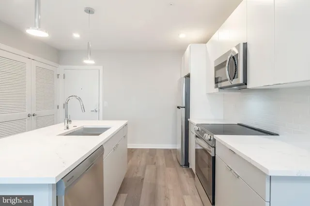 a view of a kitchen sink and a microwave