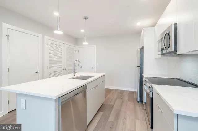 a kitchen with a sink and a refrigerator
