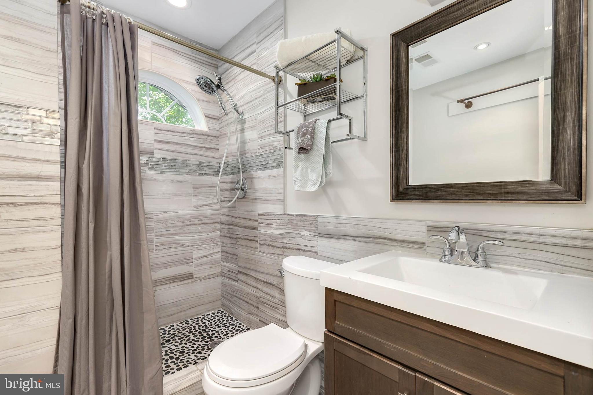 4 High Street Round Hill, VA 20141 - Photo 30 of 51 a bathroom with a sink a toilet a mirror and shower