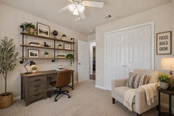 a view of a livingroom with workspace and a couch