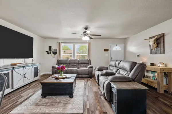 a living room with furniture and a flat screen tv