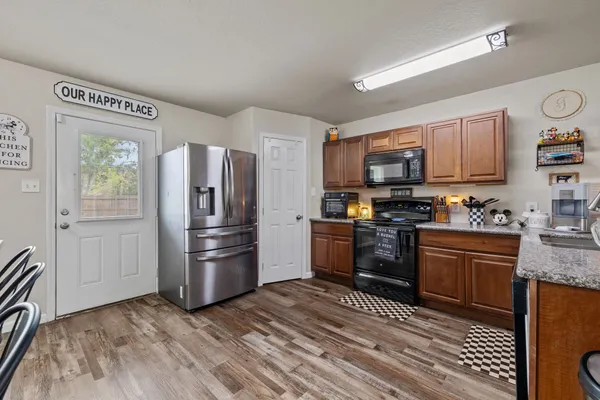 a kitchen with stainless steel appliances granite countertop a refrigerator stove and oven