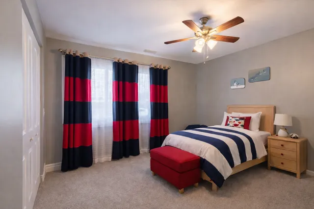 a bedroom with a bed and a chandelier