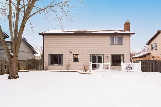 a view of a house with snow on the road