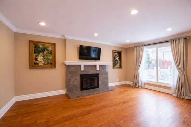 a view of an empty room with a fireplace and a window