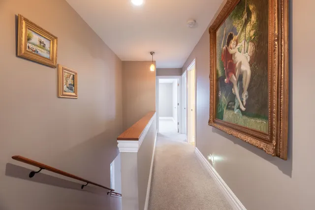 a view of a hallway with paintings on the wall