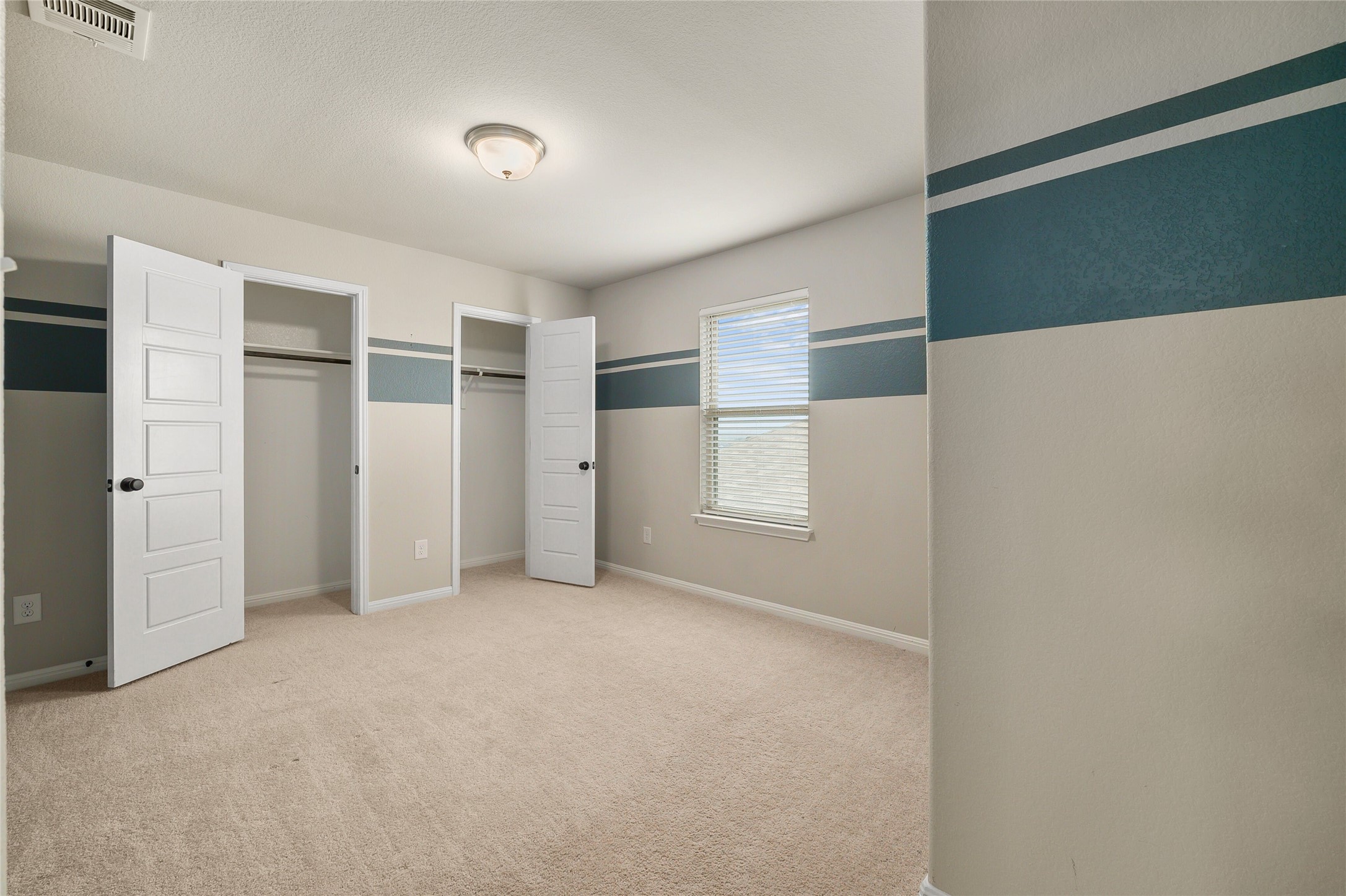 101 Lambert Street Leander, TX 78641 - Photo 20 of 33 A well-lit bedroom provides comfortable carpeting and ample closet space.